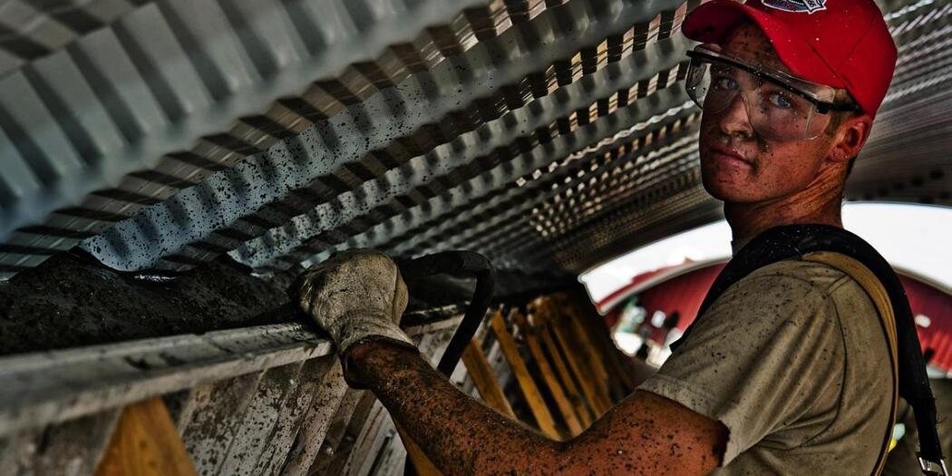 Construction worker holding a ladder