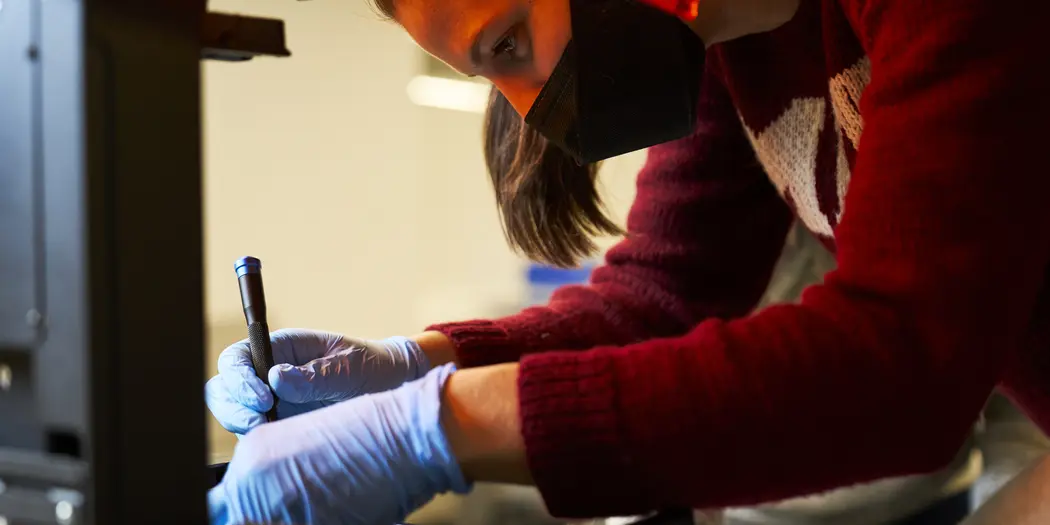 LGO student Lisa Schleuter taking apart 3D printer