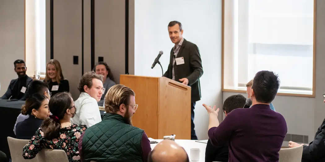 Austin Whitman and panel take a question from the audience
