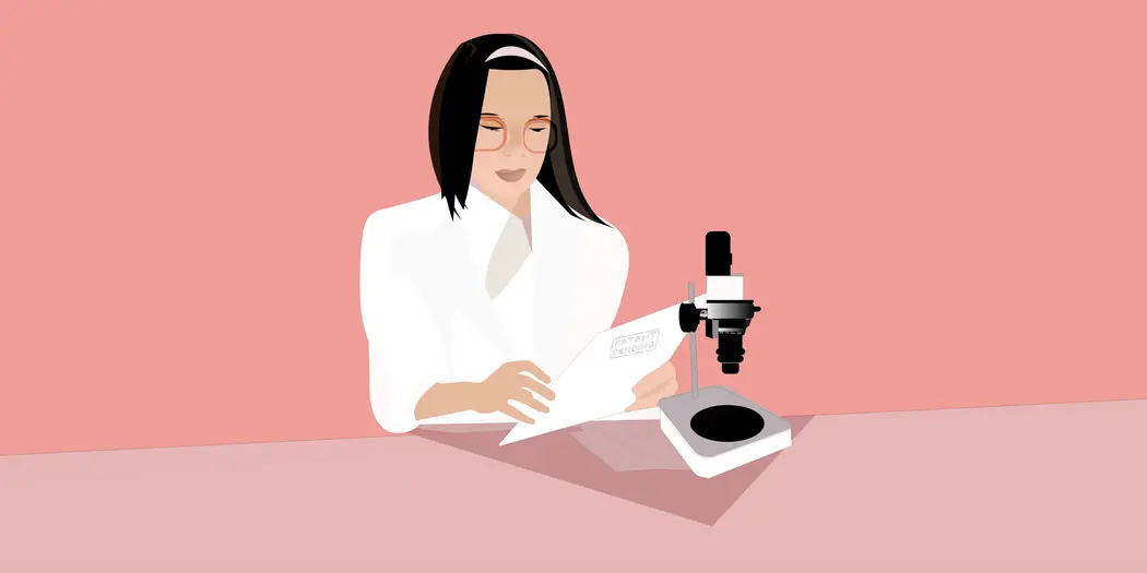 A stem researcher with microscope looks at a document with the stamp "patent pending."