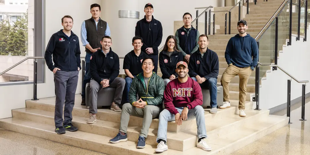 A group of people poses for a photo on a staircase
