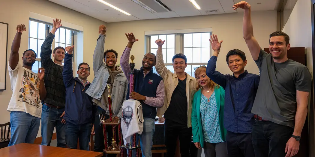 Interim Dean Perakis poses with MIT Sloan Basketball Club men's team