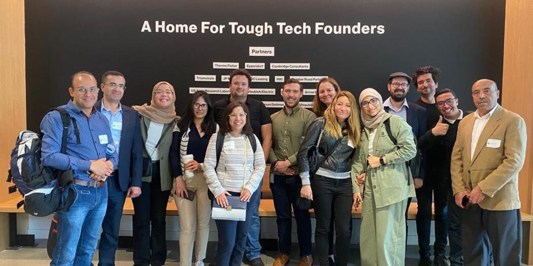 Group of entrepreneurs infront of a sign that reads a home for touch tech founders