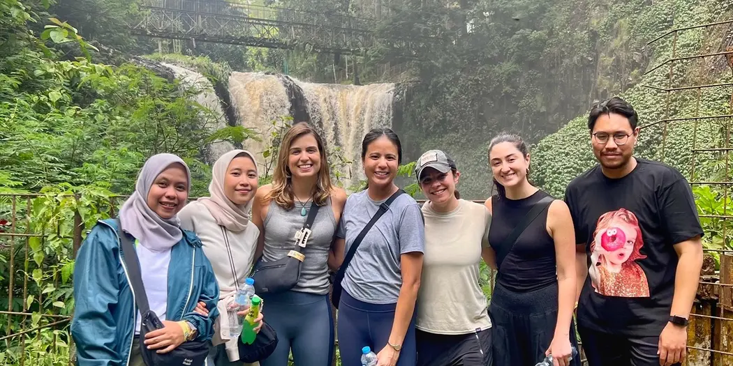 Photo of G-Lab team in front of a waterfall