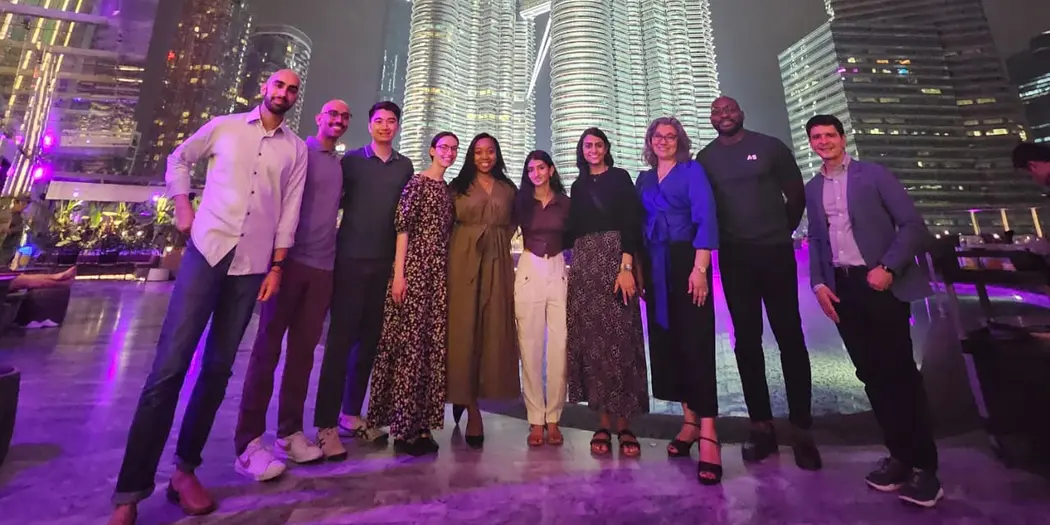 ASEAN Lab ASB teams and hosts standing in front of brightly lit tower at night in Kuala Lumpur, Malaysia