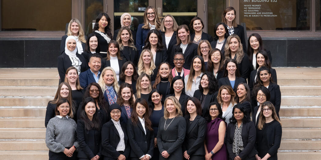 MIT EMBA Class of 2025 women on the steps outside of MIT building E52