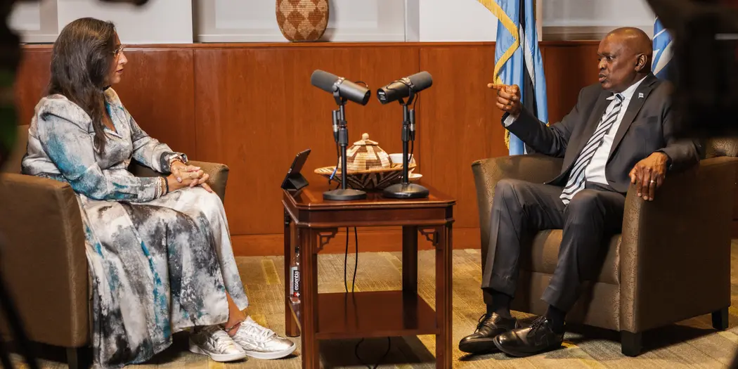 Photo of two people in chairs having a conversation