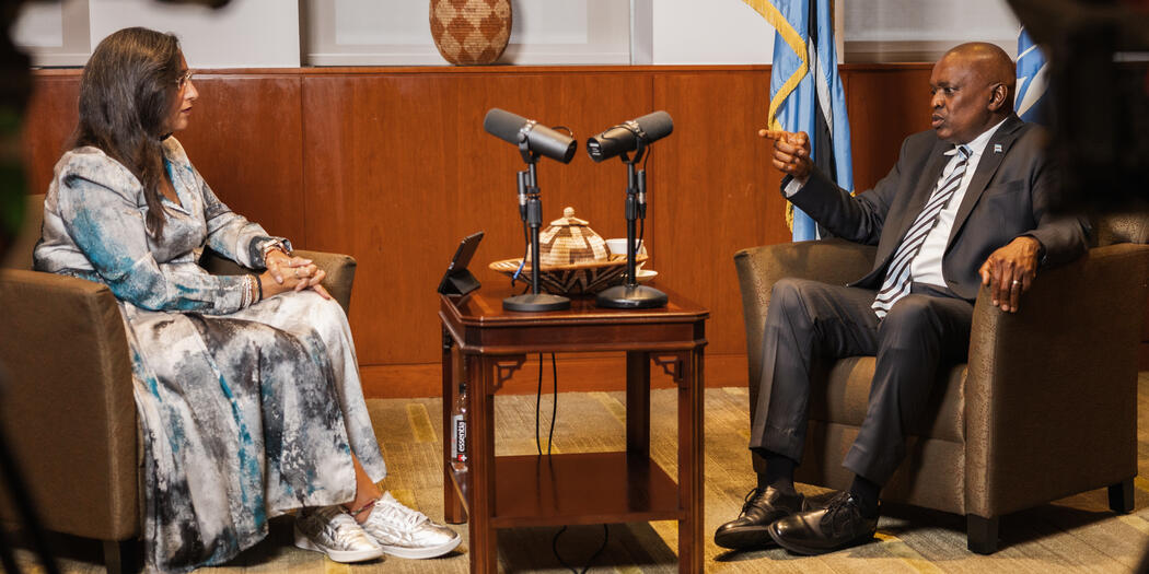 Photo of two people in chairs having a conversation