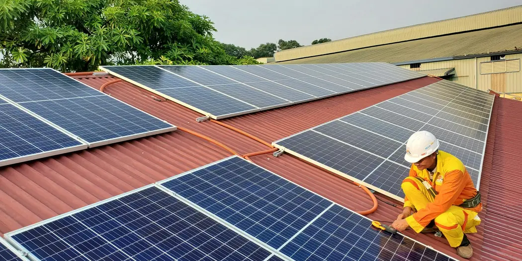 A construction worker installing solar panels