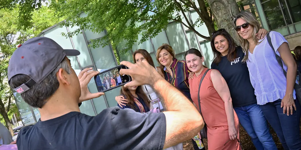 Man taking photo of group outside of building