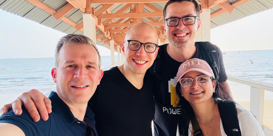 Four GO-Lab students posing under a gazebo near the ocean in Sierra Leone.