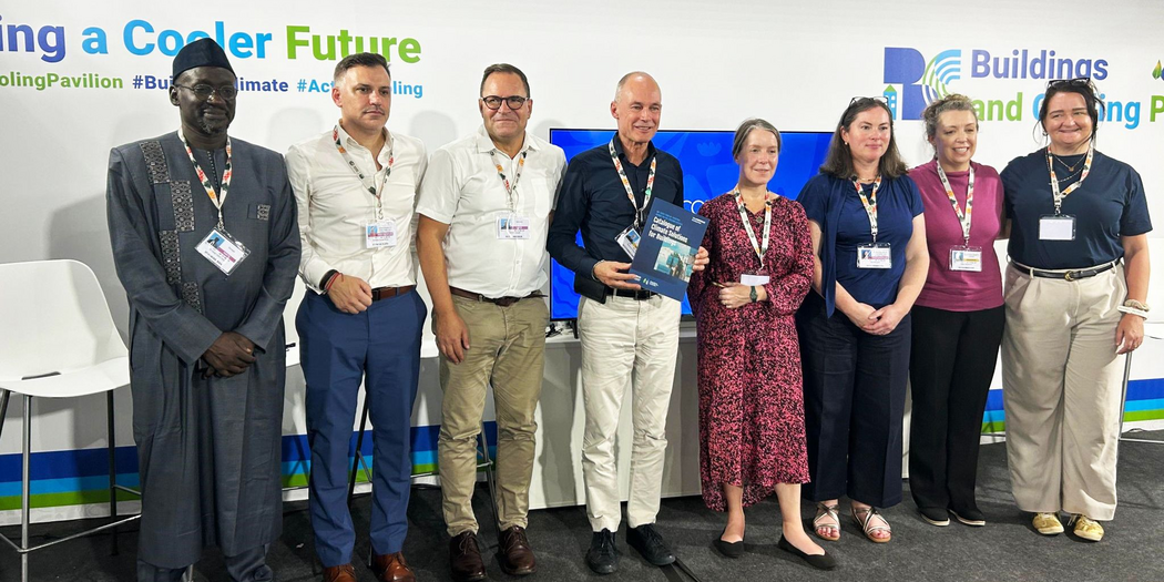 Panelists, moderator, event organizers pose for group photo