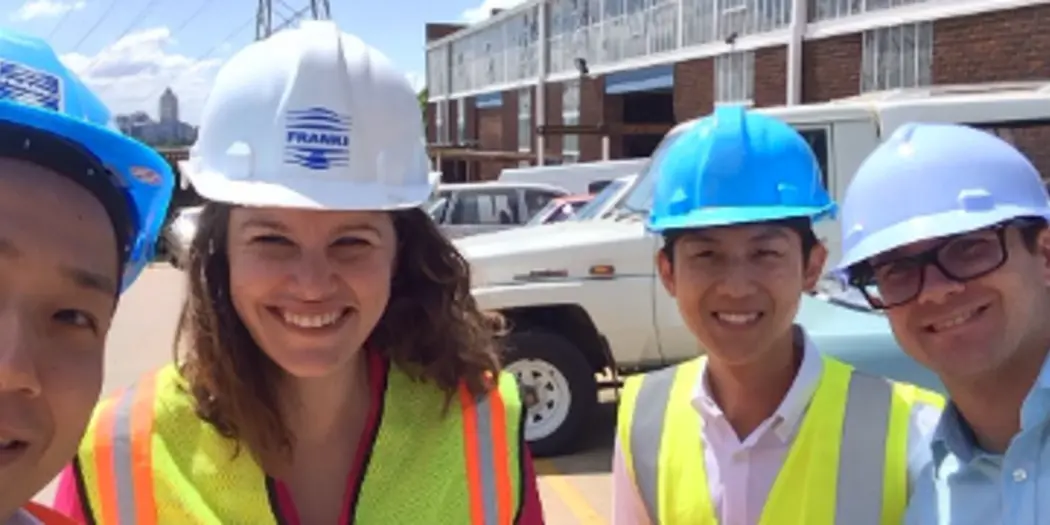 Students and host in hard hats and yellow reflective vests