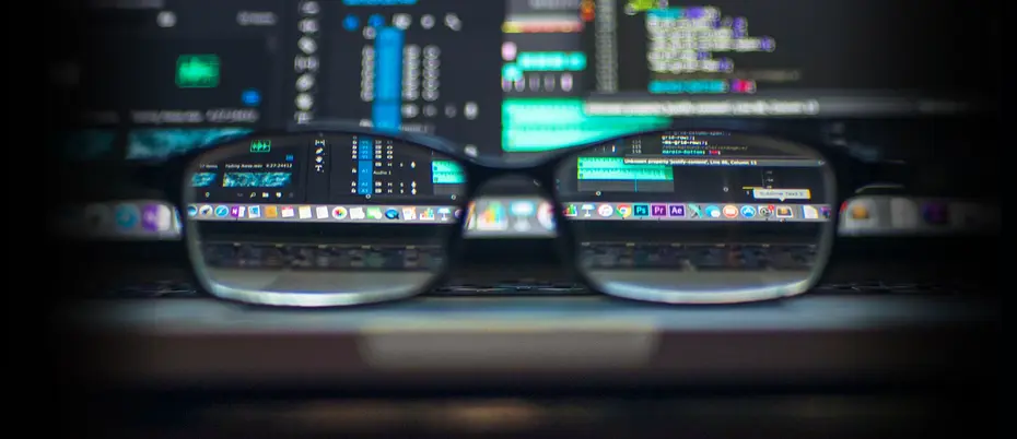 Eyeglasses on desk viewing software on screen