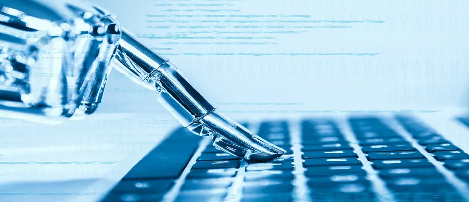 Robot hand typing on computer keyboard