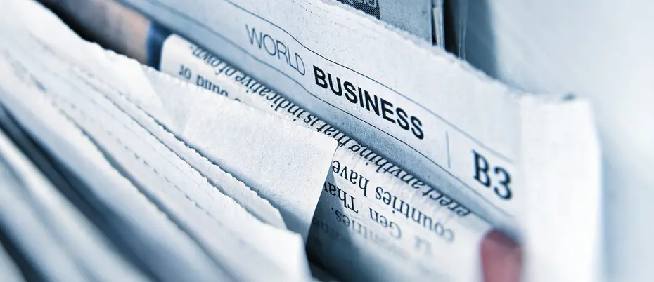 Newspapers with world business section showing