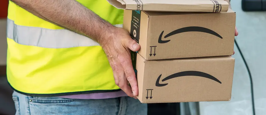 Delivery man holding Amazon boxes
