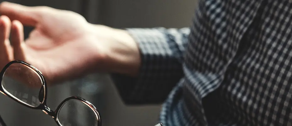 Woman talking with hands holding glasses