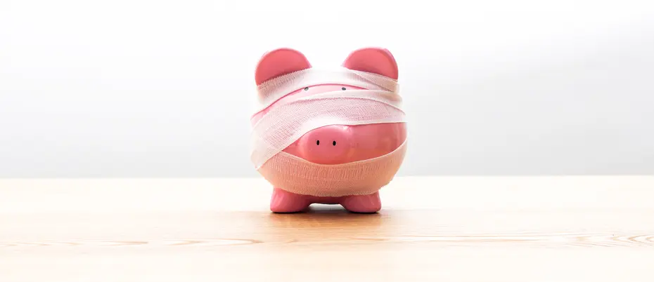 image of a pink piggy bank wrapped in white gauze bandages