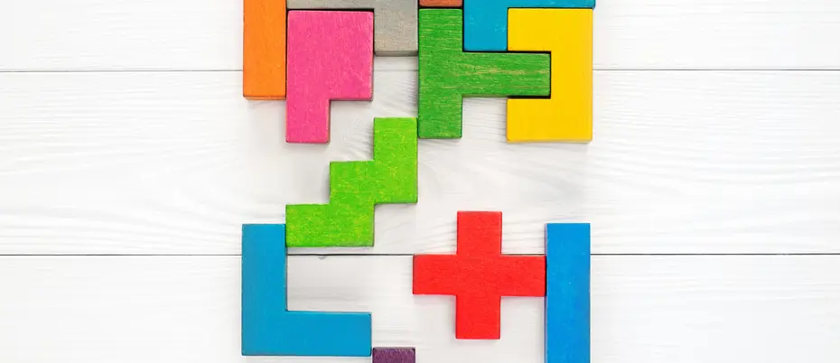 Block puzzle pieces of various colors almost fitting together