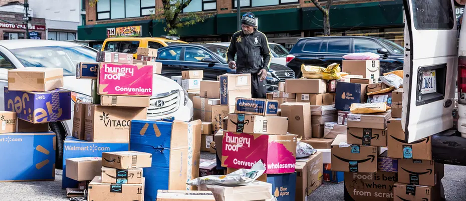A curbside full of packages from vendors such as Amazon, Walmart, Blue Apron, and others