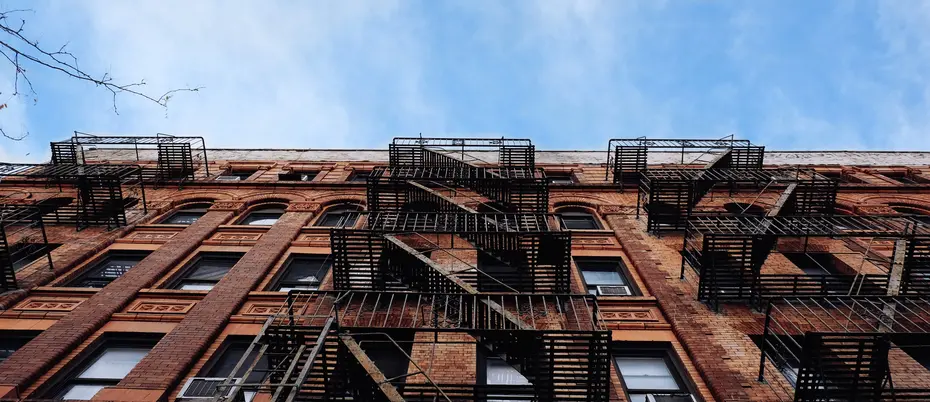 Street view looking up of brown brick building in urban setting