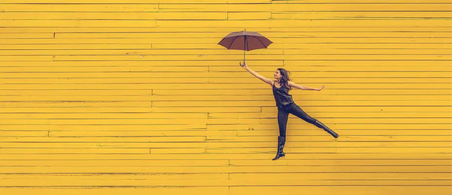 Woman with umbrella happily dancing/floating away.