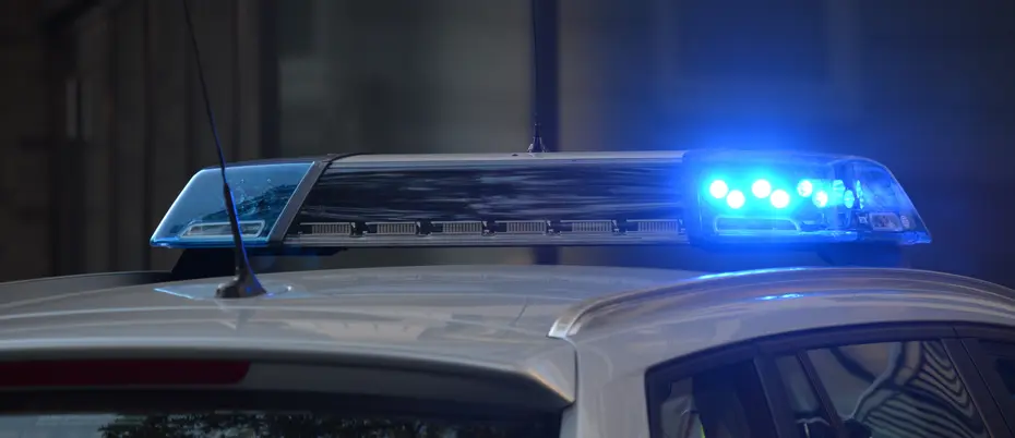 Police vehicle with blue emergency light turned on
