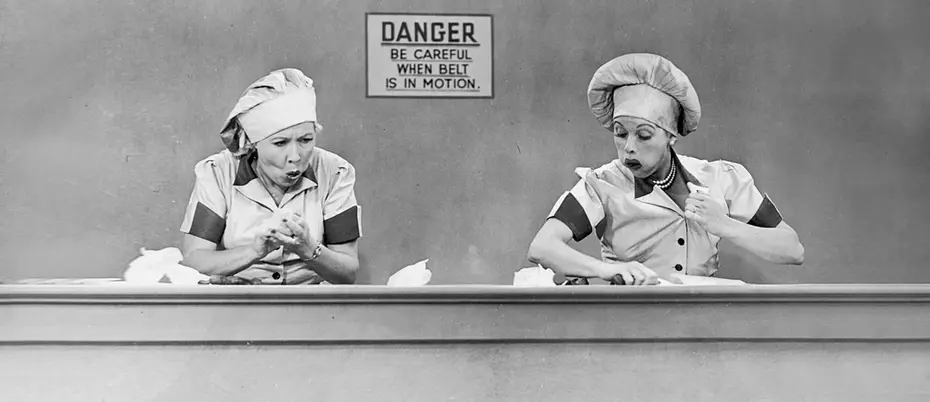 Still of Lucy and Ethel working at the candy factory from I Love Lucy 