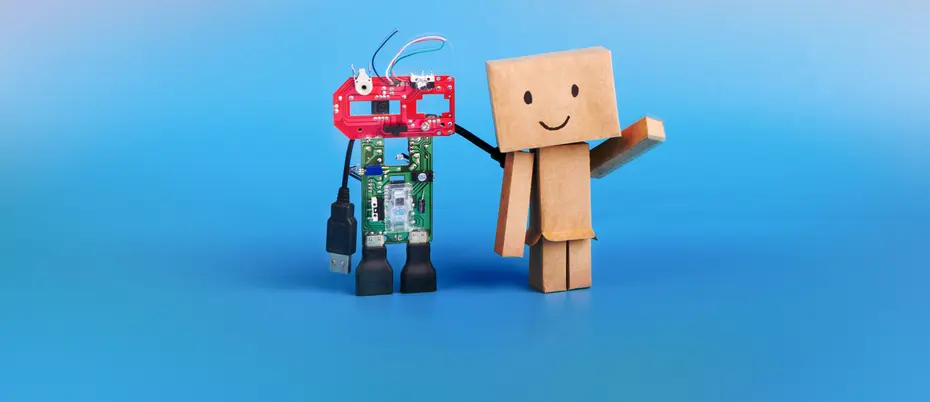 robot and smiling carboard human holding hands