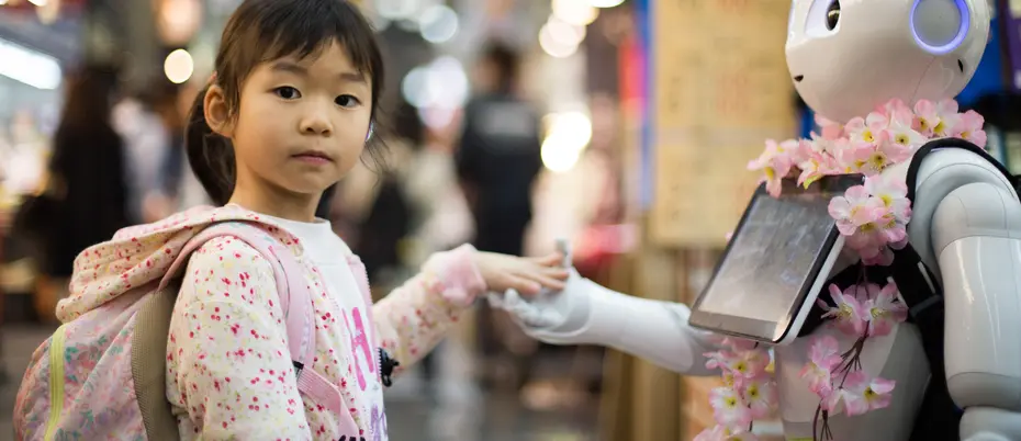 Photo of girl touching hand of robot