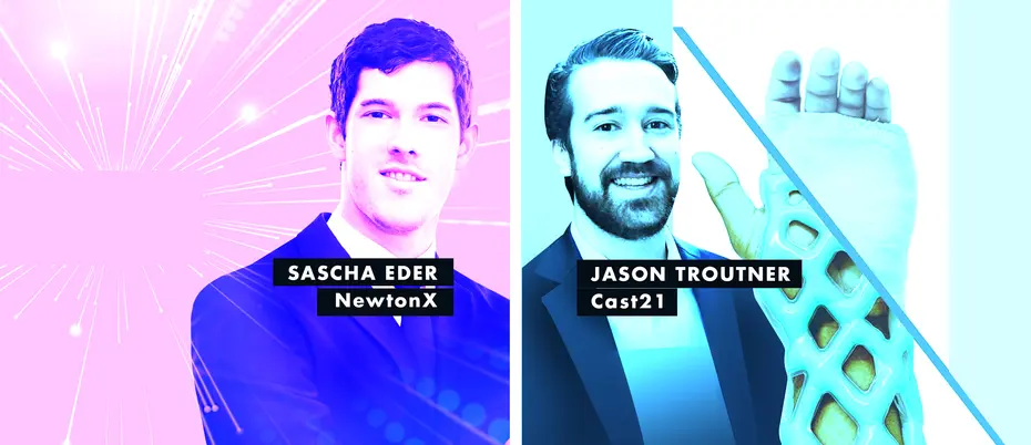 two men smiling in front of a pink and blue background