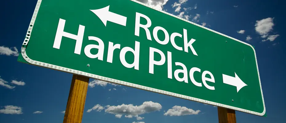 Green sign with words arrowing pointing left next to words reading "Rock" and arrow pointing right next to words "Hard Place" 