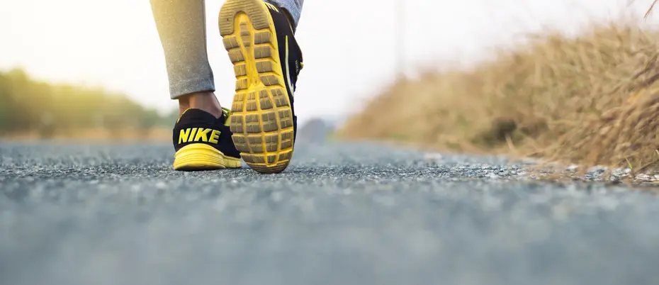 Person taking step wearing Nike shoes