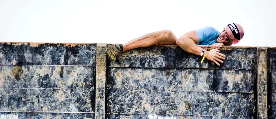 Person climbing over wall