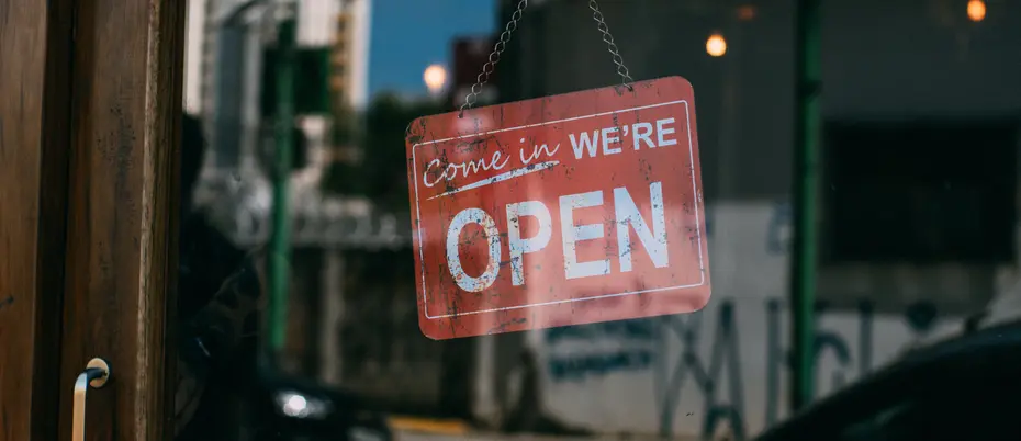 "Come in, we're open" sign hanging in doorway