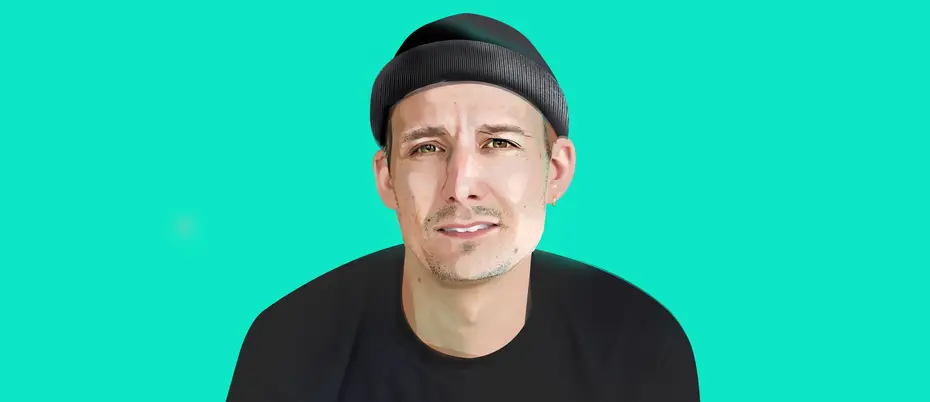 Mikkel Christopher smiles at the camera with a mint green background 