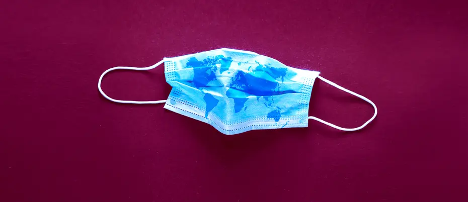 A picture of a medical mask with a pattern of a world map on it, representing people worldwide taking measures to slow the spread of the coronavirus.