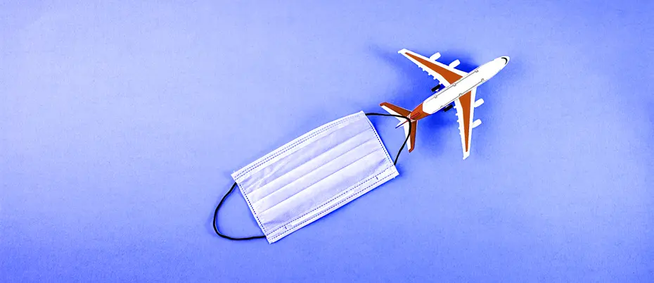 Image of airplane with a face mask trailing behind.