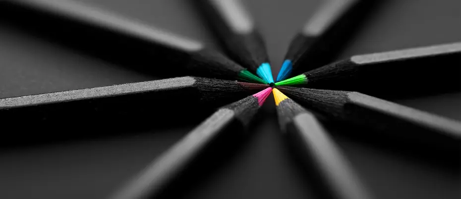 black pencils with colored points meet in a pinwheel