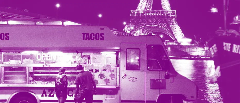 Taco truck at night in front of the Eiffel Tower