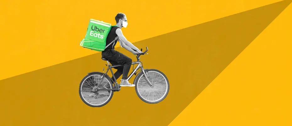 Photo illustration of an Uber Eats worker on a bicycle carrying an Uber Eats delivery bag.
