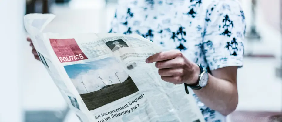 Person holding the politics section of a newspaper. Research finds variations of voters’ knowledge of political news across age, gender, race and socioeconomic status.