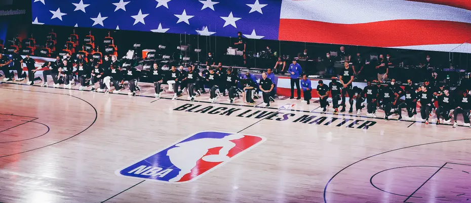 The Miami Heat and Milwaukee Bucks take a knee during the National Anthem prior to Game One of the Eastern Conference Second Round during the 2020 NBA Playoffs at the Field House at ESPN Wide World Of Sports Complex on August 31, 2020 in Lake Buena Vista, Florida.