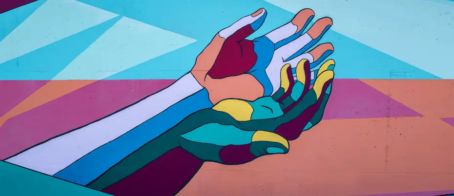 a mural painting of two hands morphing into one