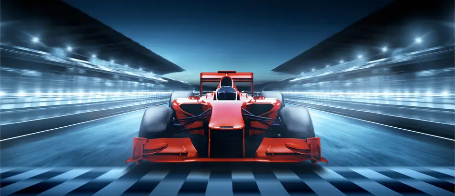 Image of a Formula 1 car racing at night.