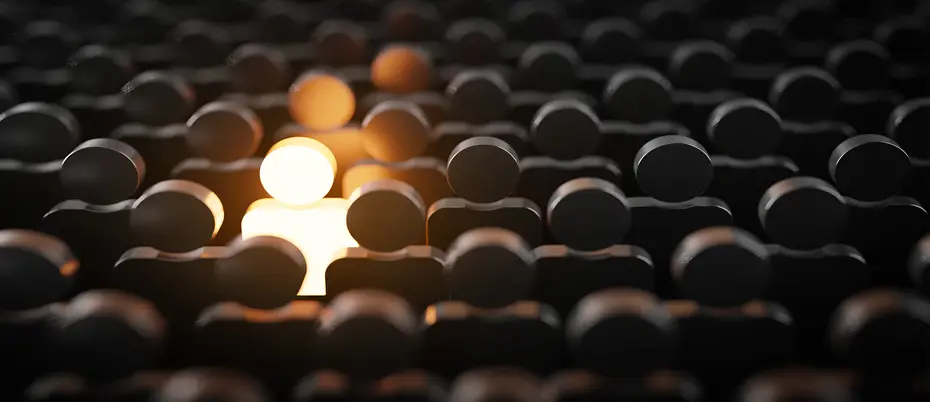 a glowing figure stands out in a crowd to represent diversity hiring barriers