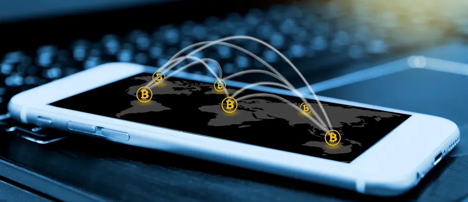 mobile phone with small bitcoin symbols bouncing on its face, meant to represent fintech and blockchain