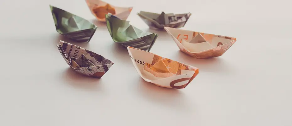 Origami boats made out of paper currency from various countries 