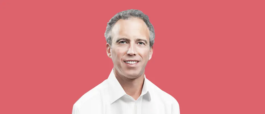Frederic Kerrest, co-founder, executive vice chairman, identity management company Okta, smiles at the viewer, over a pink-red background